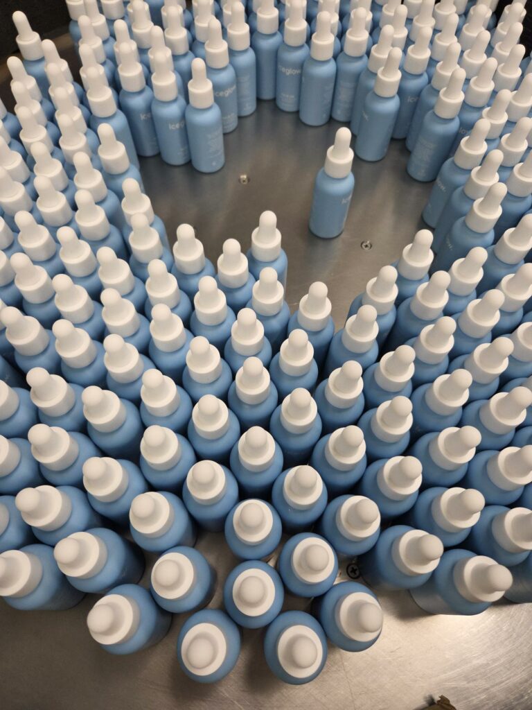 Rows of cosmetic dropper bottles ready for liquid filling at an Australian contract manufacturing facility
